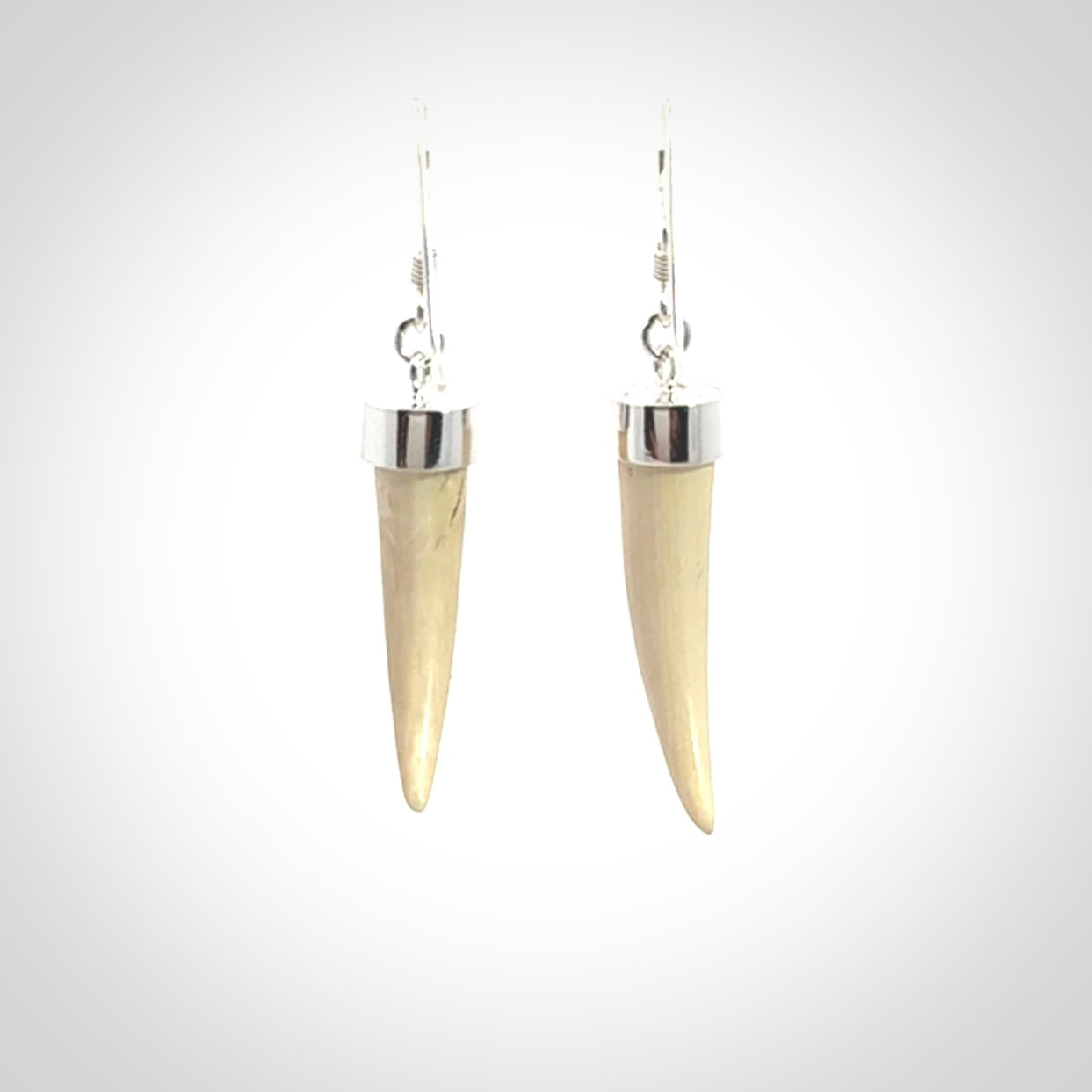 Hand made mammoth tusk drop earrings. Made by NZ Pacific - handmade jewellery for sale online. Woolly Mammoth Tusk fang style earrings, packaged in a woven kete pouch.