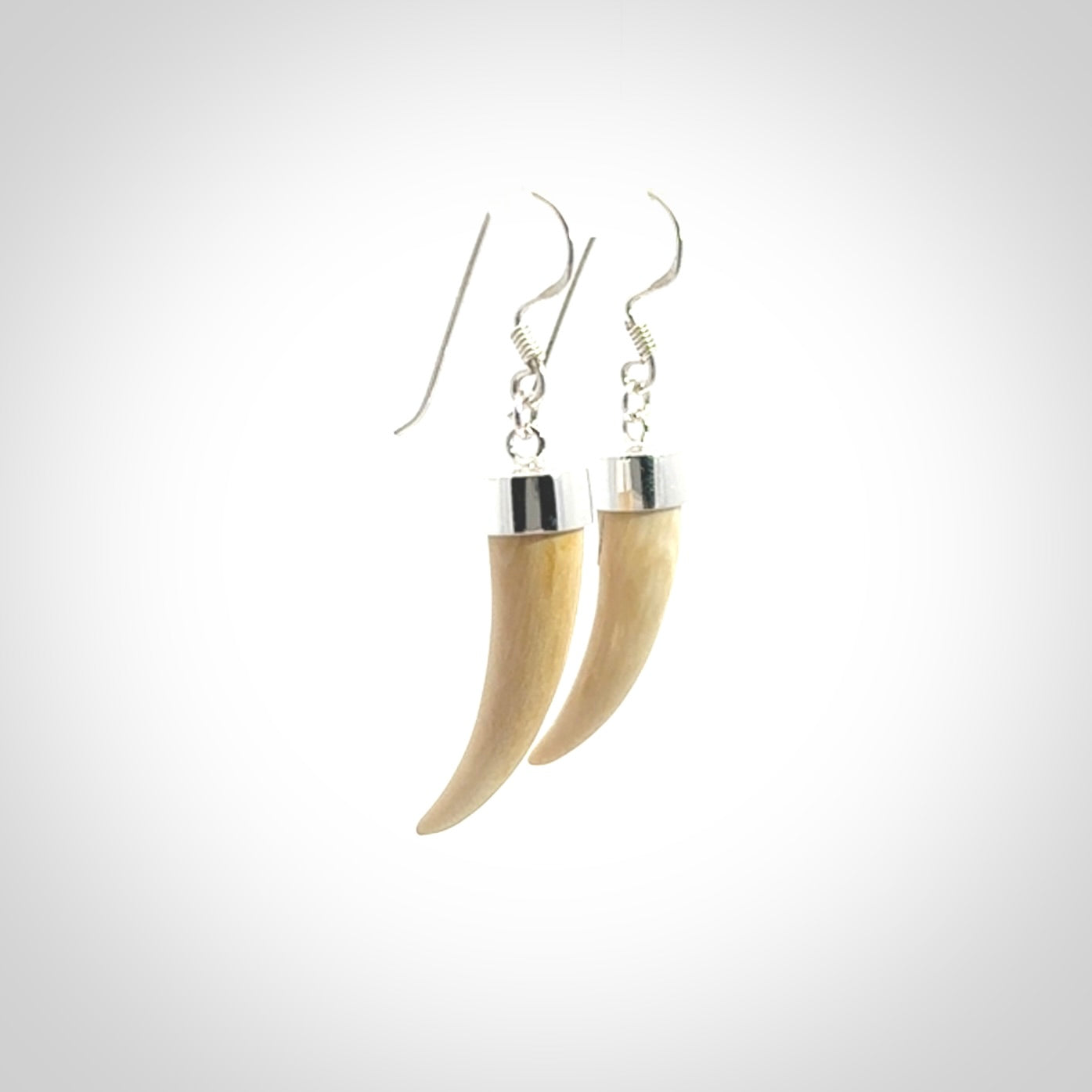Hand made mammoth tusk drop earrings. Made by NZ Pacific - handmade jewellery for sale online. Woolly Mammoth Tusk fang style earrings, packaged in a woven kete pouch.