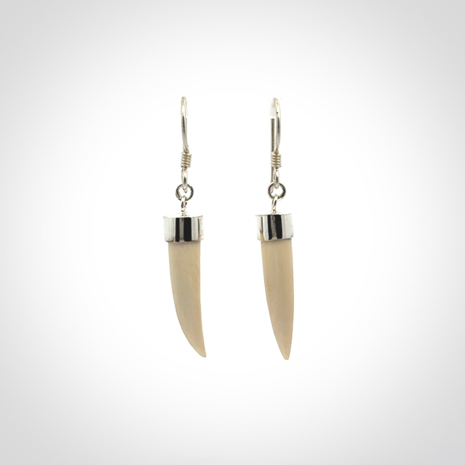 Hand made mammoth tusk drop earrings. Made by NZ Pacific - handmade jewellery for sale online. Woolly Mammoth Tusk fang style earrings, packaged in a woven kete pouch.