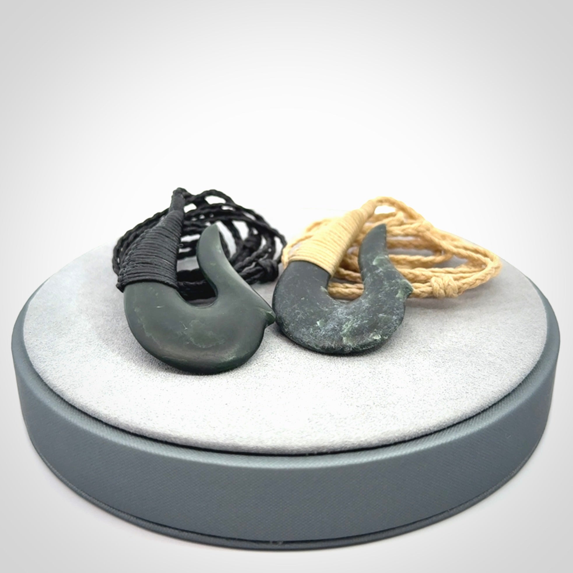This photo shows a greenstone hook, or matau, pendant. It is a beautiful deep green jade. The cord is plaited and the length can be adjusted.