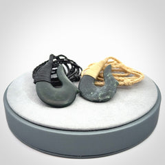 This photo shows a greenstone hook, or matau, pendant. It is a beautiful deep green jade. The cord is plaited and the length can be adjusted.