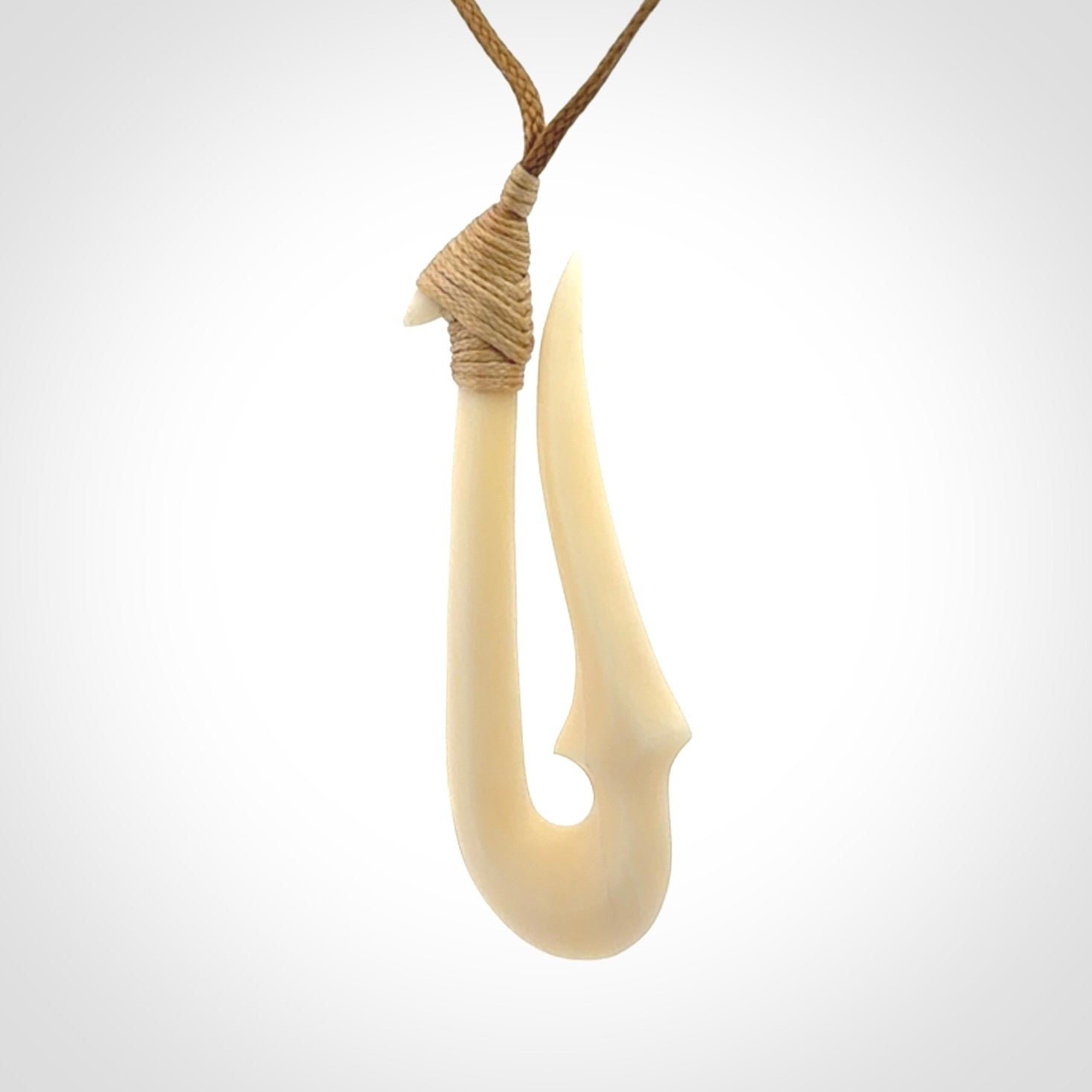 Hand made bone hook, or matau, pendant. The cord can be adjusted. It is a large sized pendant and is well carved. A beautiful piece of art to wear, hand carved jewellery. Delivered in woven kete pouch with express courier.
