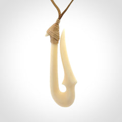 Hand made bone hook, or matau, pendant. The cord can be adjusted. It is a large sized pendant and is well carved. A beautiful piece of art to wear, hand carved jewellery. Delivered in woven kete pouch with express courier.