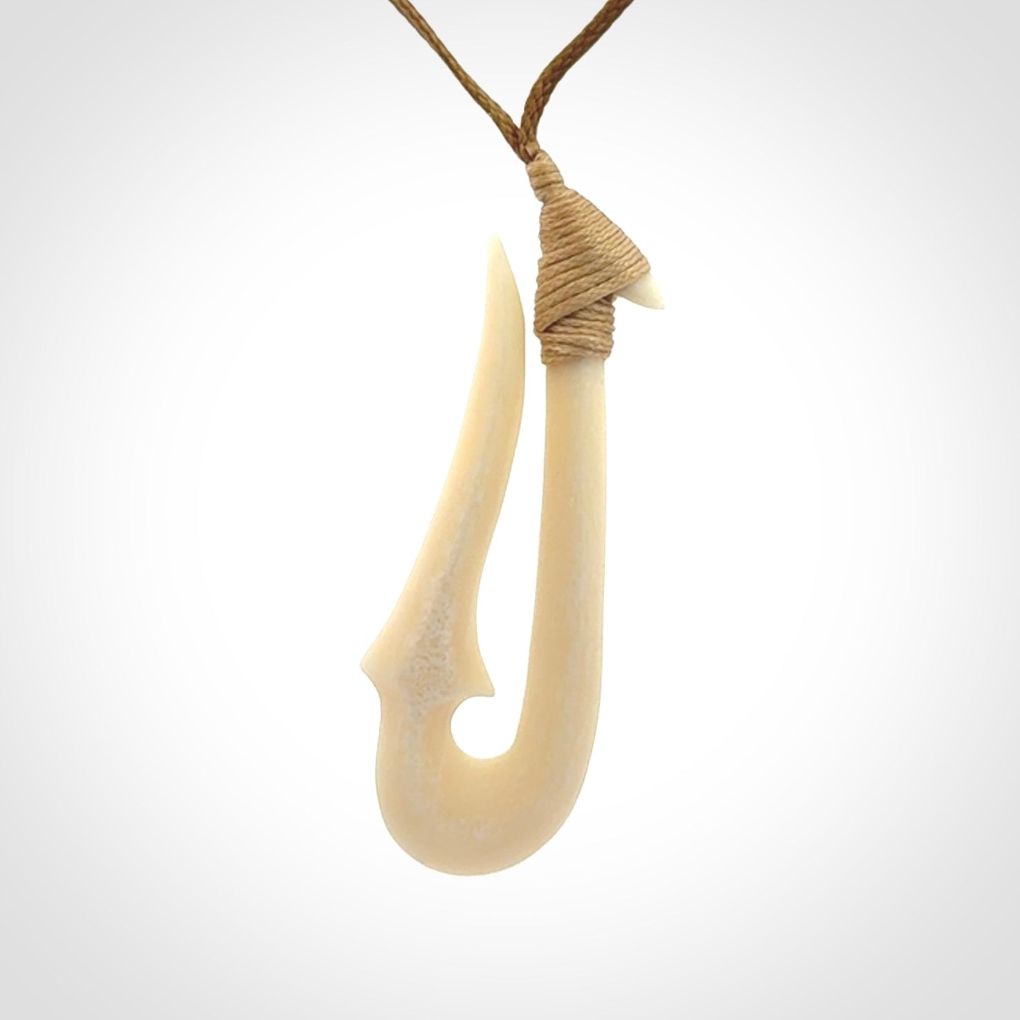 Hand made bone hook, or matau, pendant. The cord can be adjusted. It is a large sized pendant and is well carved. A beautiful piece of art to wear, hand carved jewellery. Delivered in woven kete pouch with express courier.
