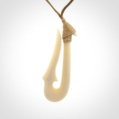 Hand made bone hook, or matau, pendant. The cord can be adjusted. It is a large sized pendant and is well carved. A beautiful piece of art to wear, hand carved jewellery. Delivered in woven kete pouch with express courier.