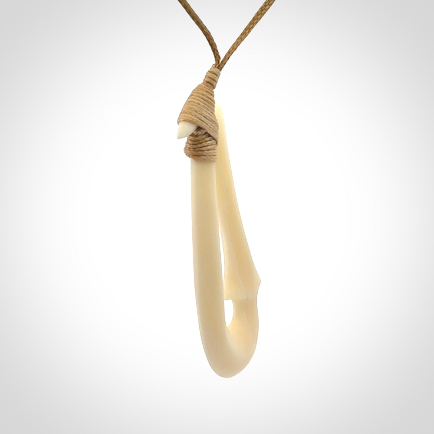 Hand made bone hook, or matau, pendant. The cord can be adjusted. It is a large sized pendant and is well carved. A beautiful piece of art to wear, hand carved jewellery. Delivered in woven kete pouch with express courier.