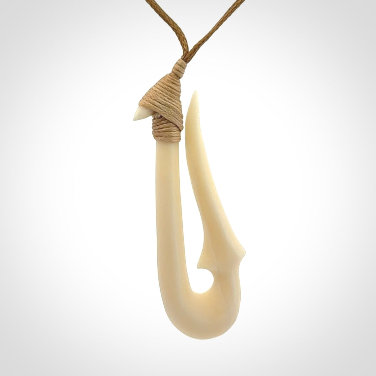 Hand made bone hook, or matau, pendant. The cord can be adjusted. It is a large sized pendant and is well carved. A beautiful piece of art to wear, hand carved jewellery. Delivered in woven kete pouch with express courier.