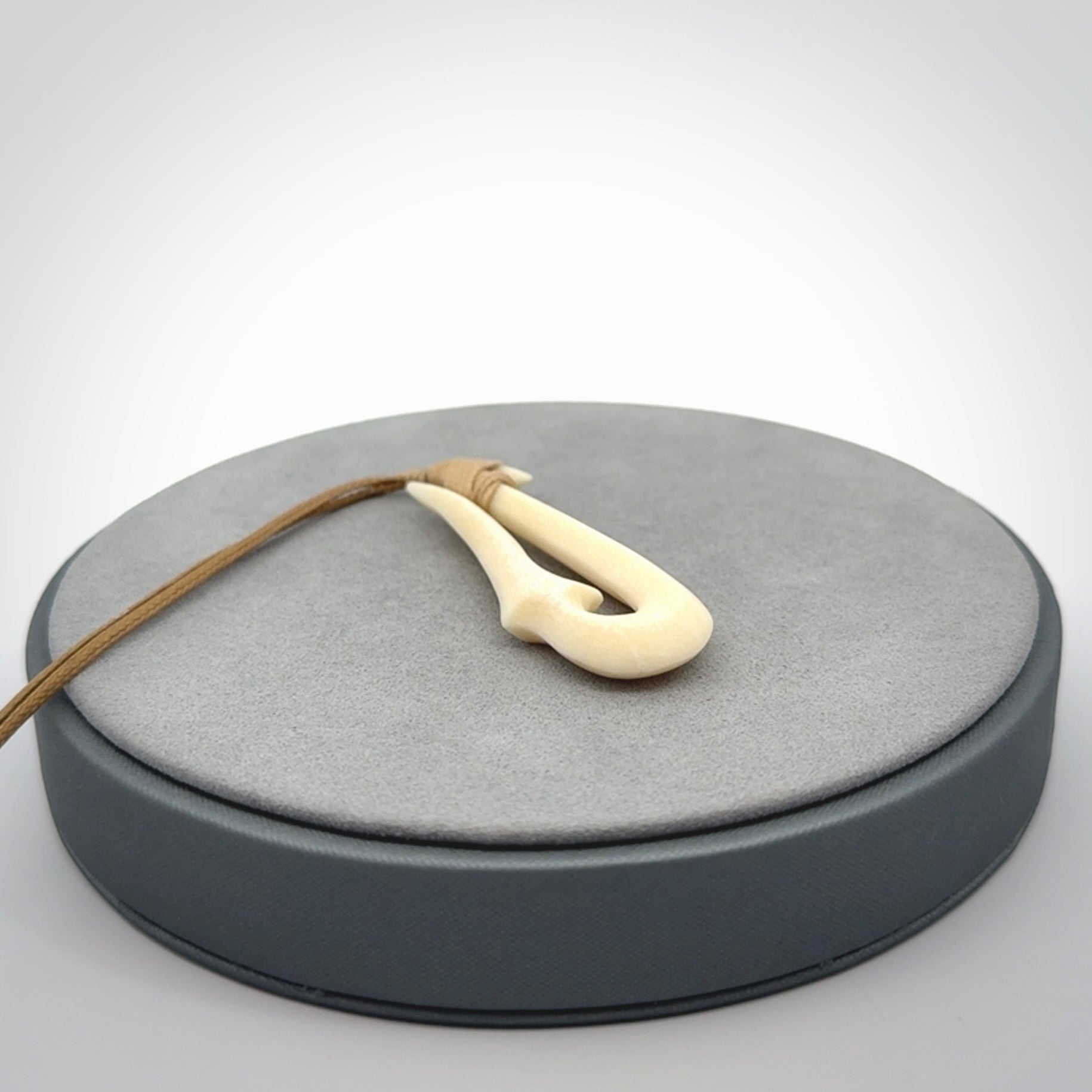 Hand made bone hook, or matau, pendant. The cord can be adjusted. It is a large sized pendant and is well carved. A beautiful piece of art to wear, hand carved jewellery. Delivered in woven kete pouch with express courier.