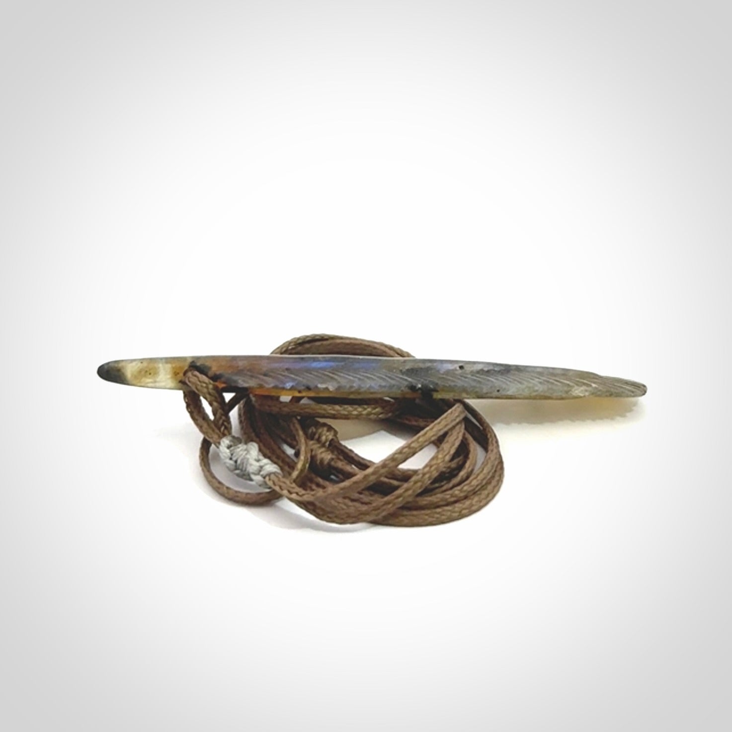This is a hand carved feather pendant made from Labradorite stone.