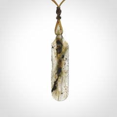 This is a hand carved feather pendant made from Labradorite stone.