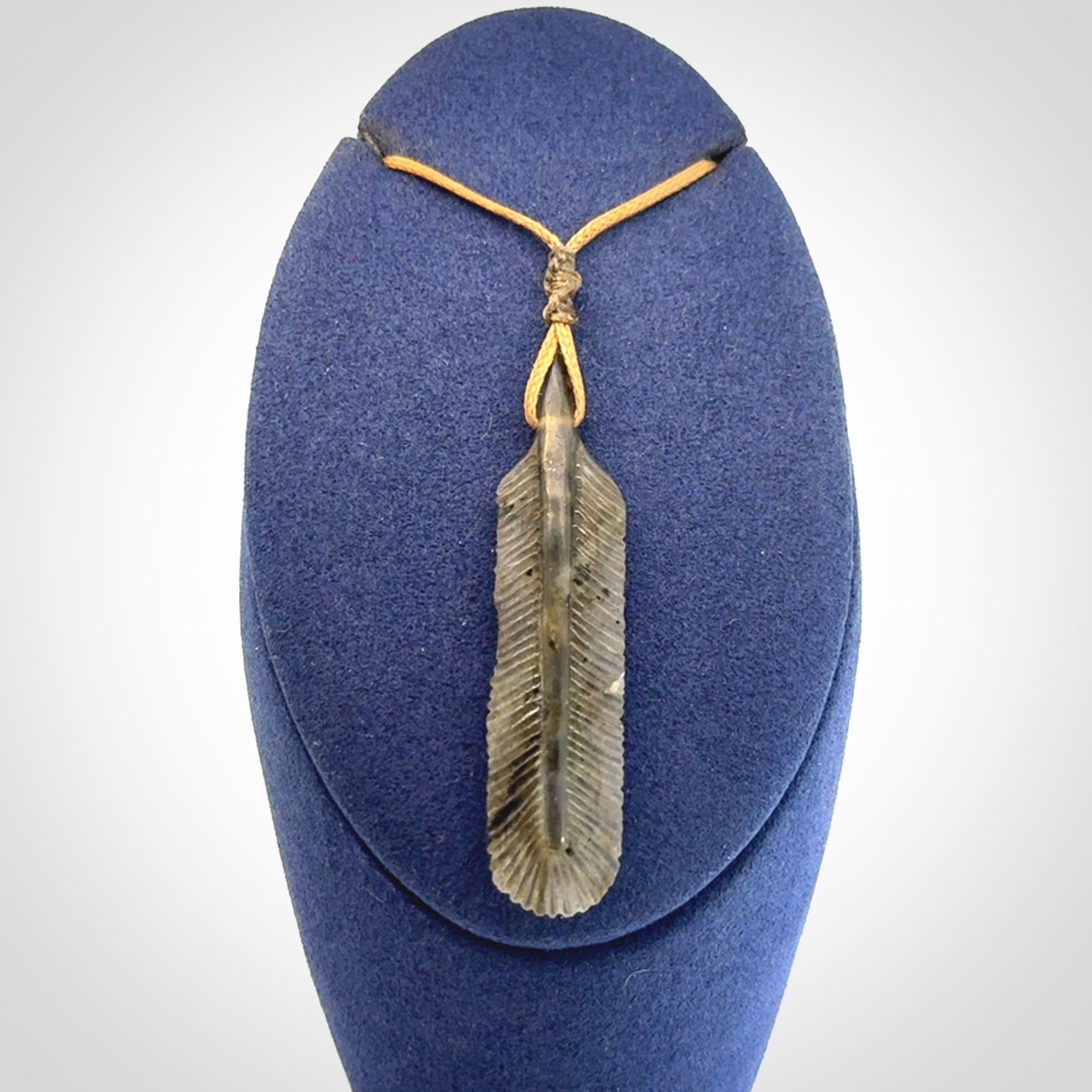 This is a hand carved feather pendant made from Labradorite stone.