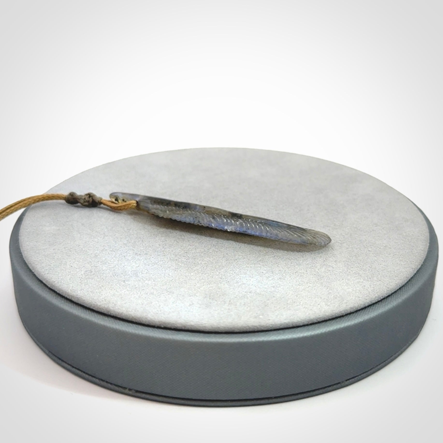 This is a hand carved feather pendant made from Labradorite stone.