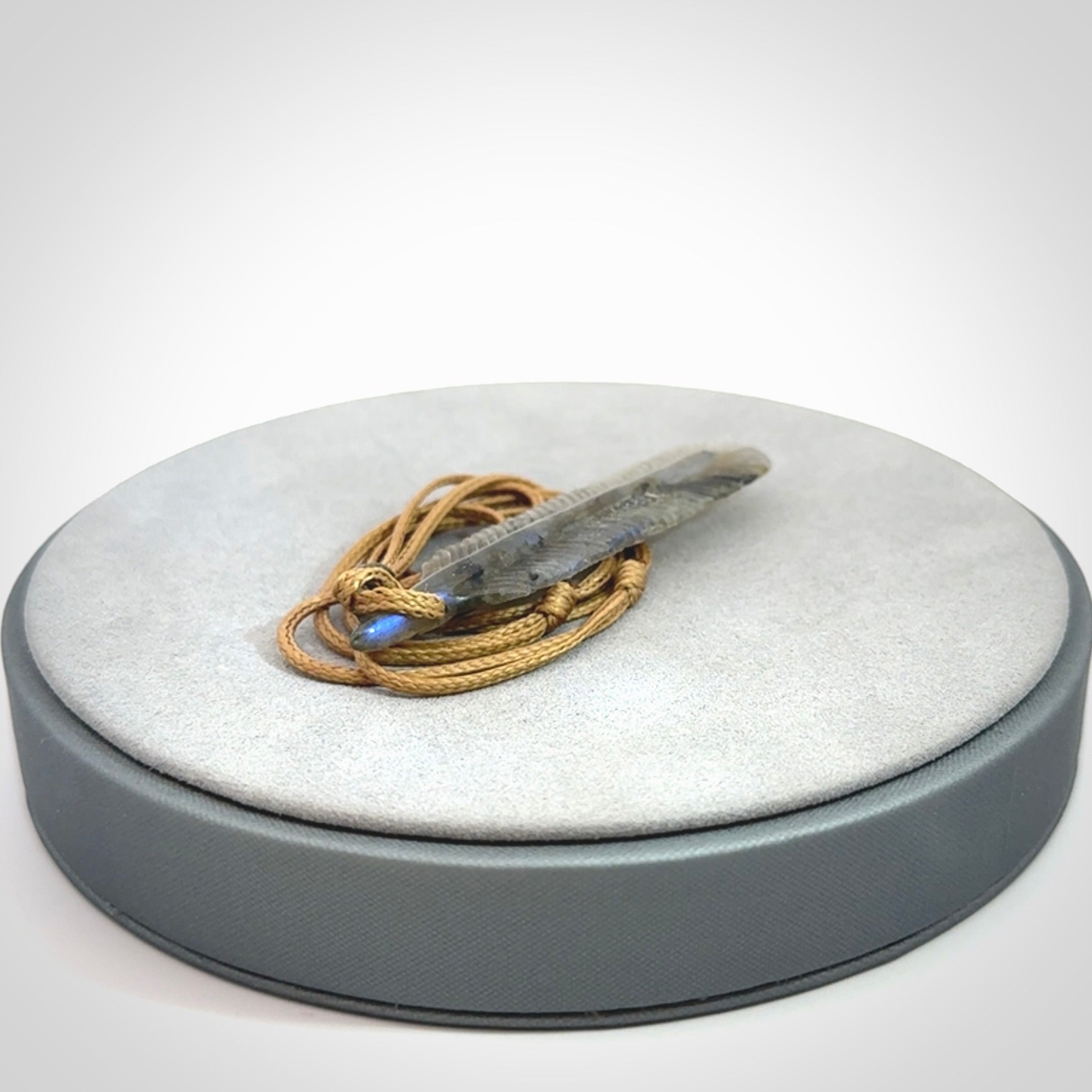 This is a hand carved feather pendant made from Labradorite stone.