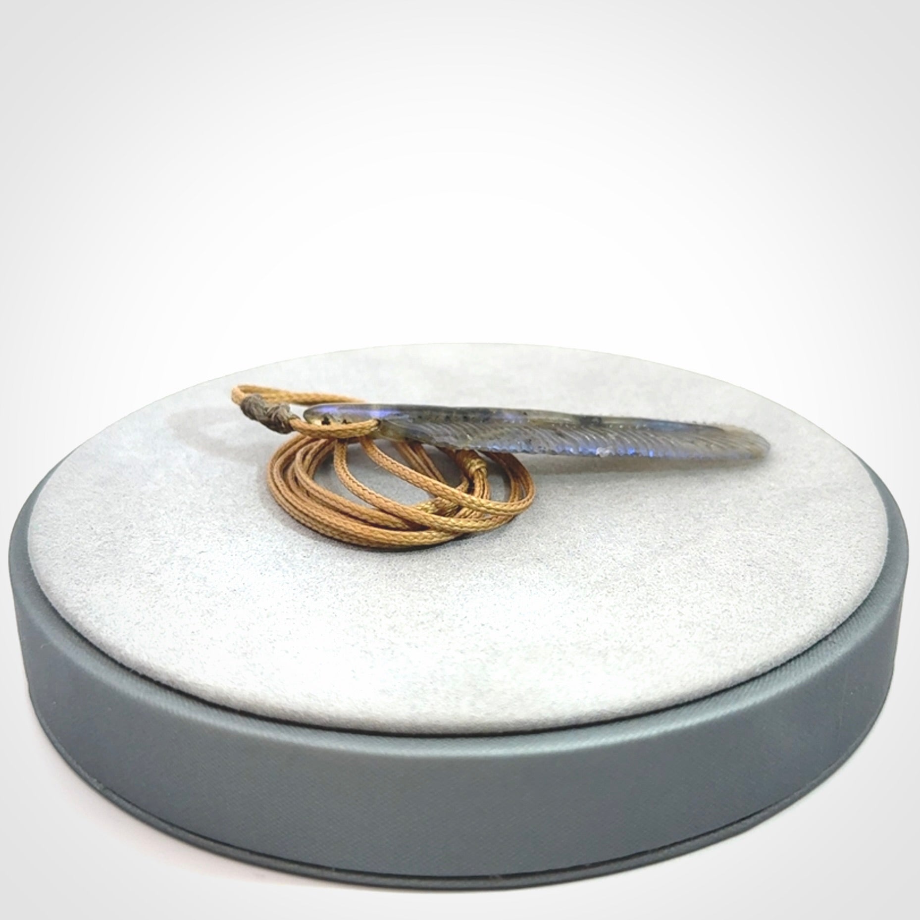 This is a hand carved feather pendant made from Labradorite stone.
