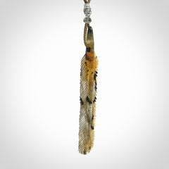 This is a hand carved feather pendant made from Labradorite stone.