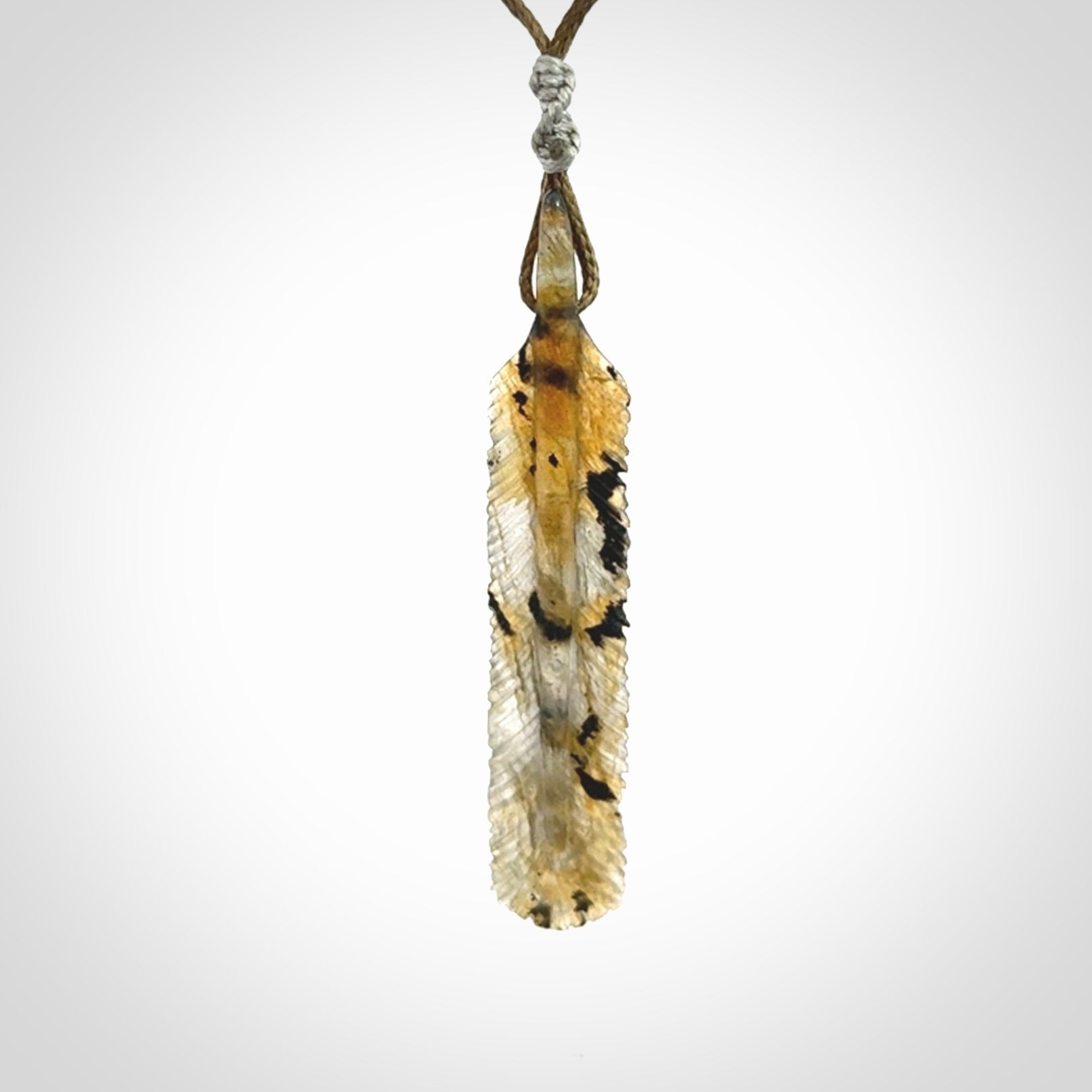 This is a hand carved feather pendant made from Labradorite stone.