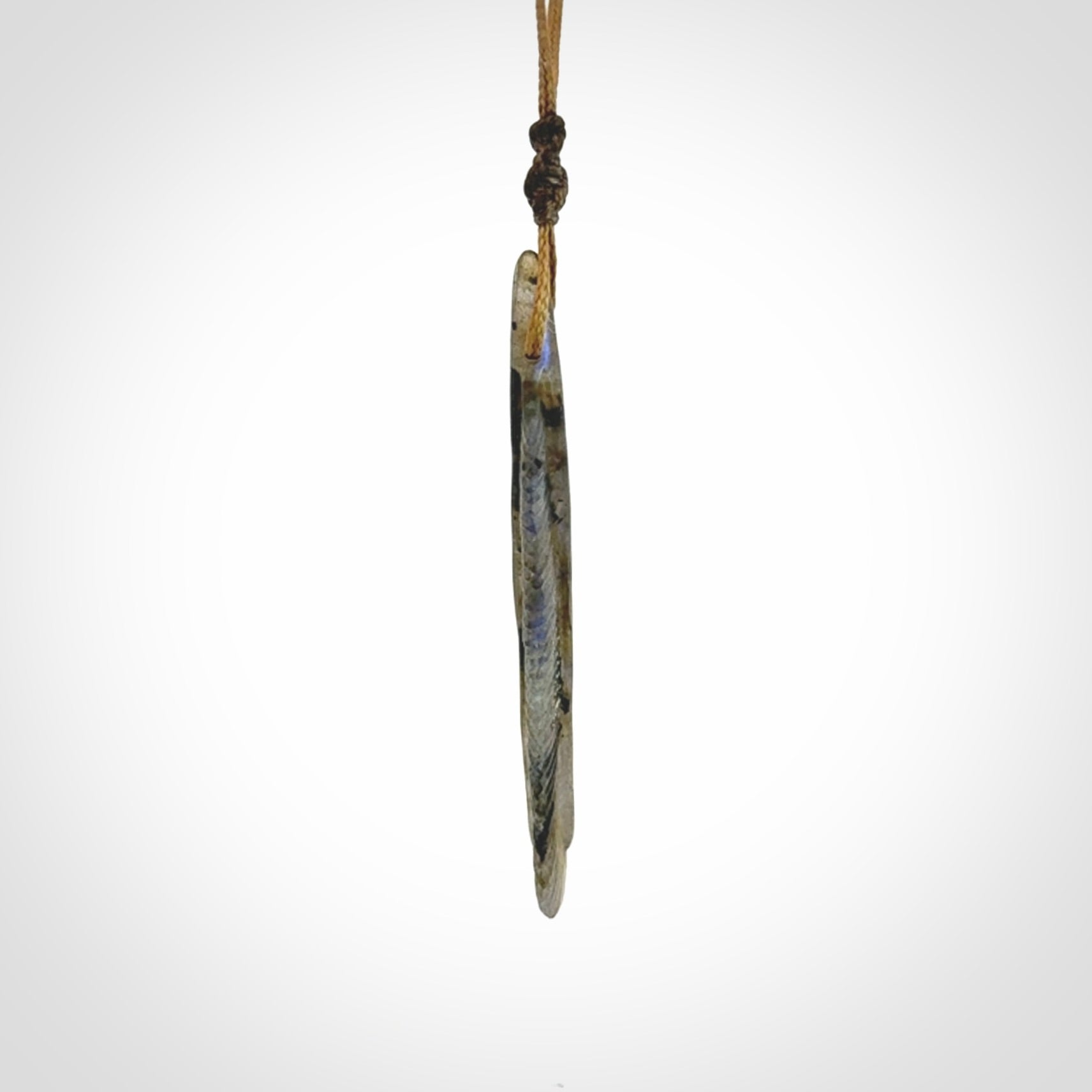 This is a hand carved feather pendant made from Labradorite stone.