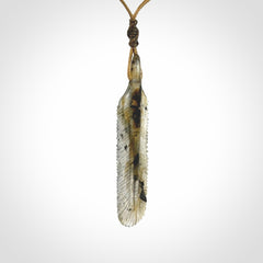 This is a hand carved feather pendant made from Labradorite stone.