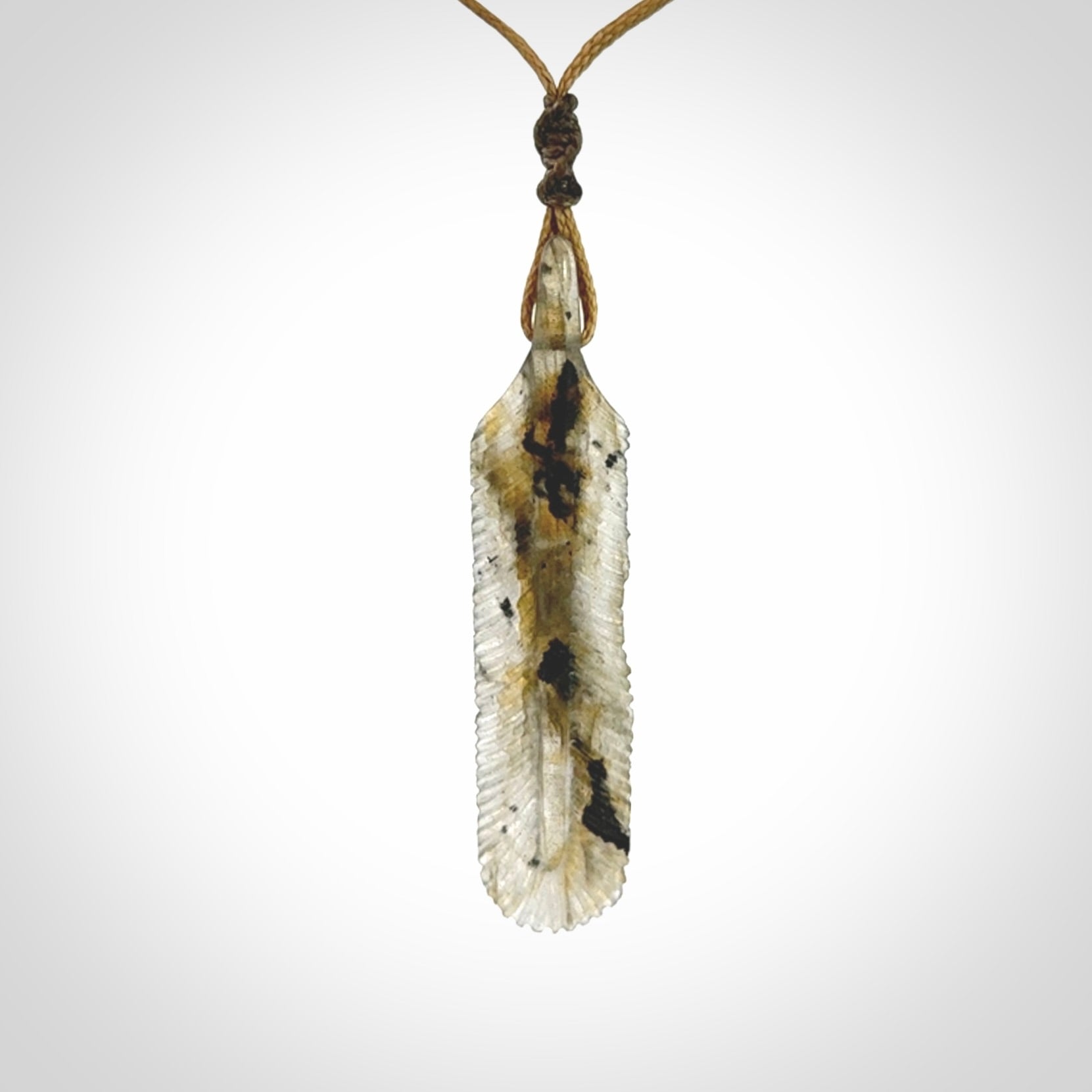 This is a hand carved feather pendant made from Labradorite stone.