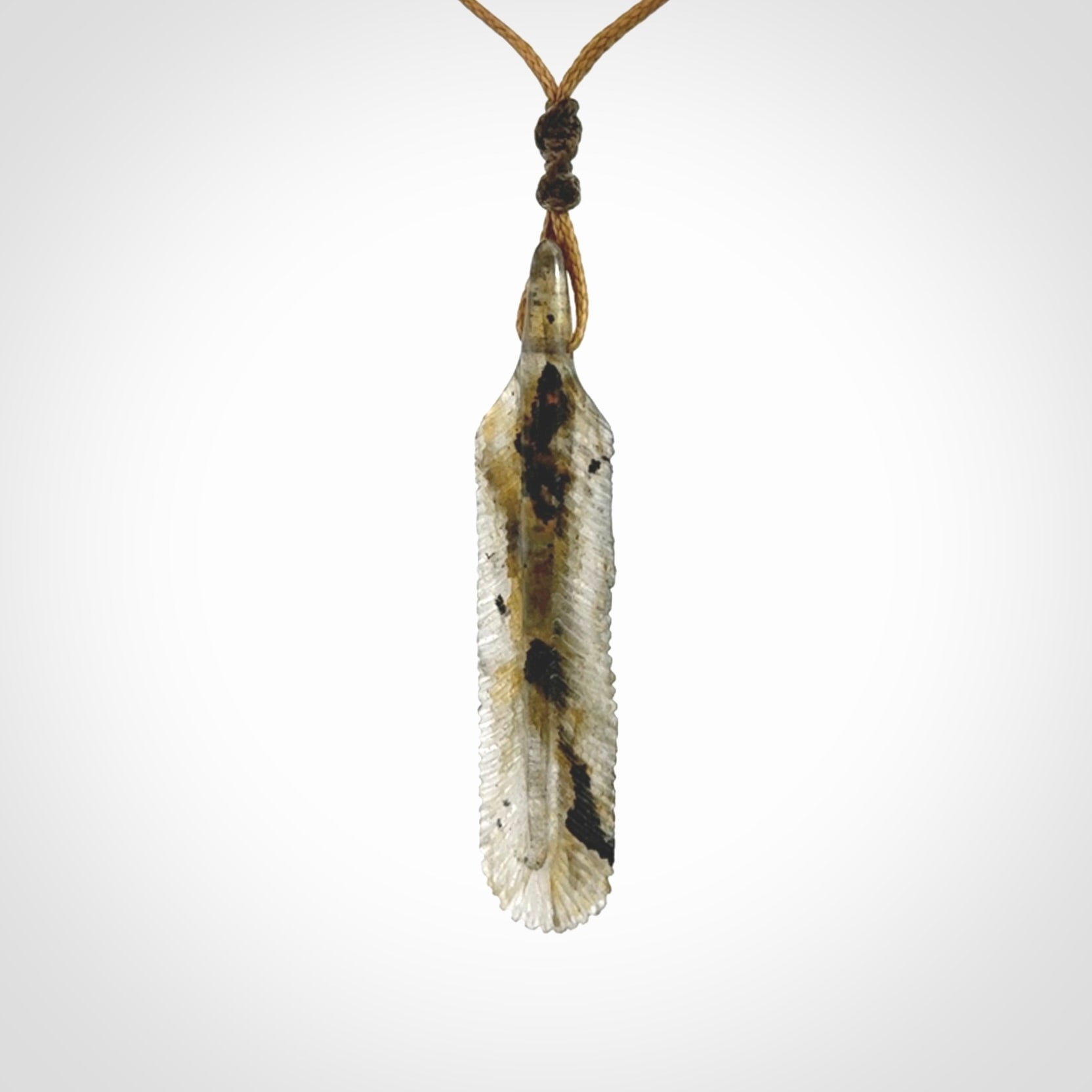 This is a hand carved feather pendant made from Labradorite stone.
