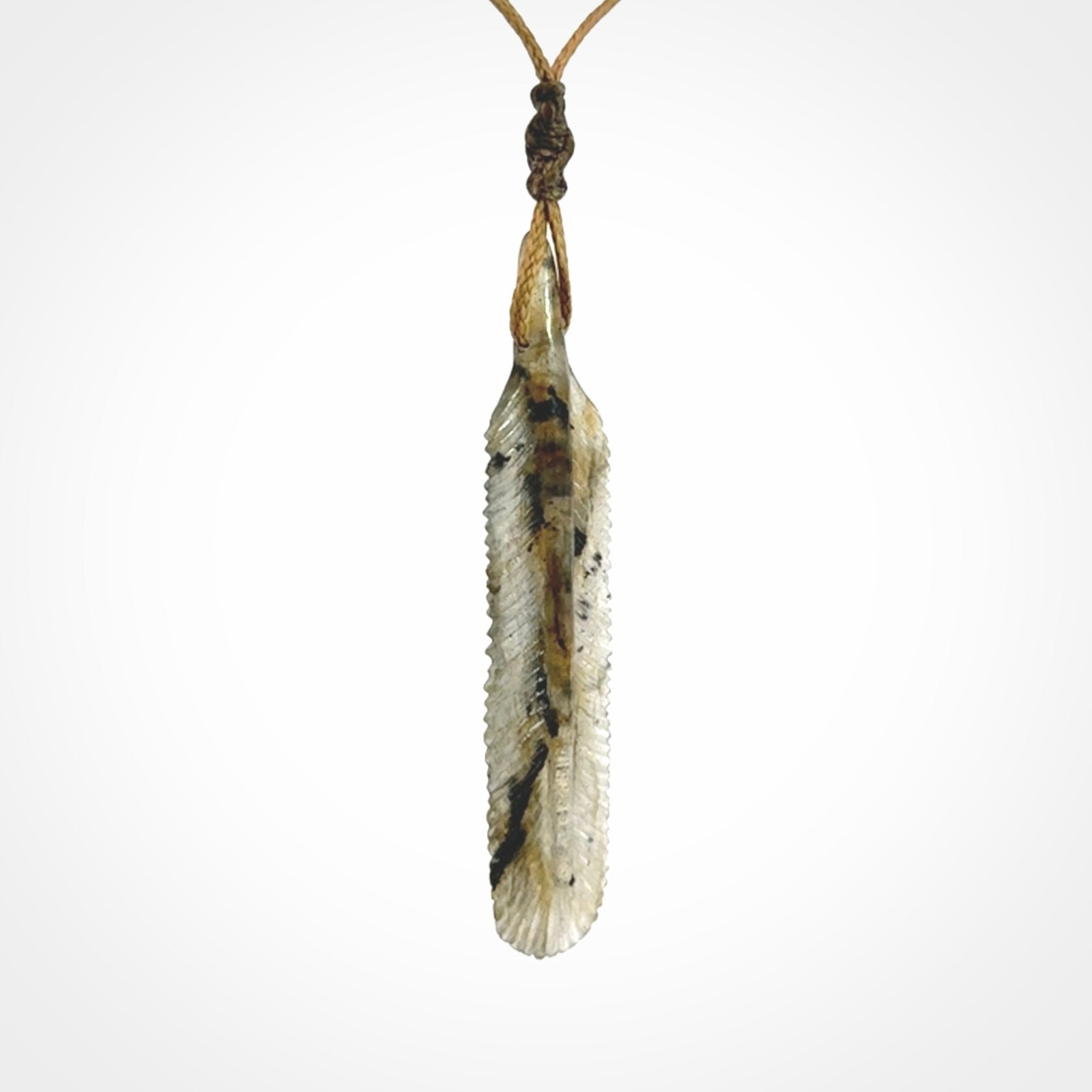 This is a hand carved feather pendant made from Labradorite stone.
