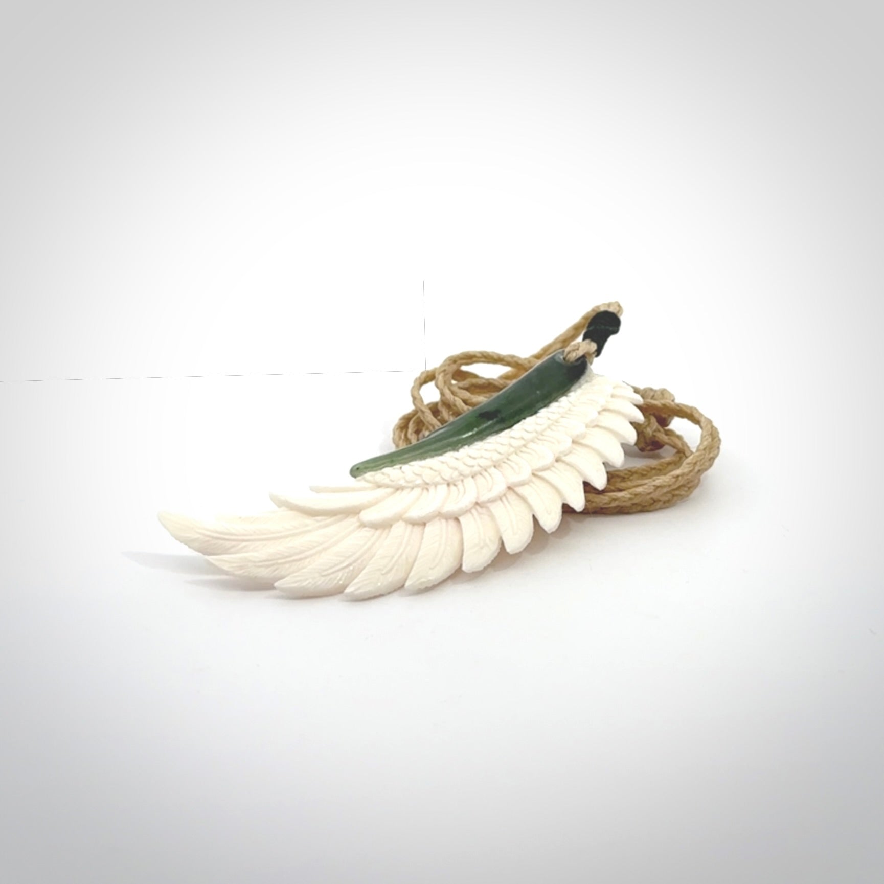 This photo shows a beautiful bone and jade wing pendant.