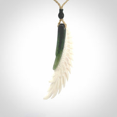 This photo shows a beautiful bone and jade wing pendant.