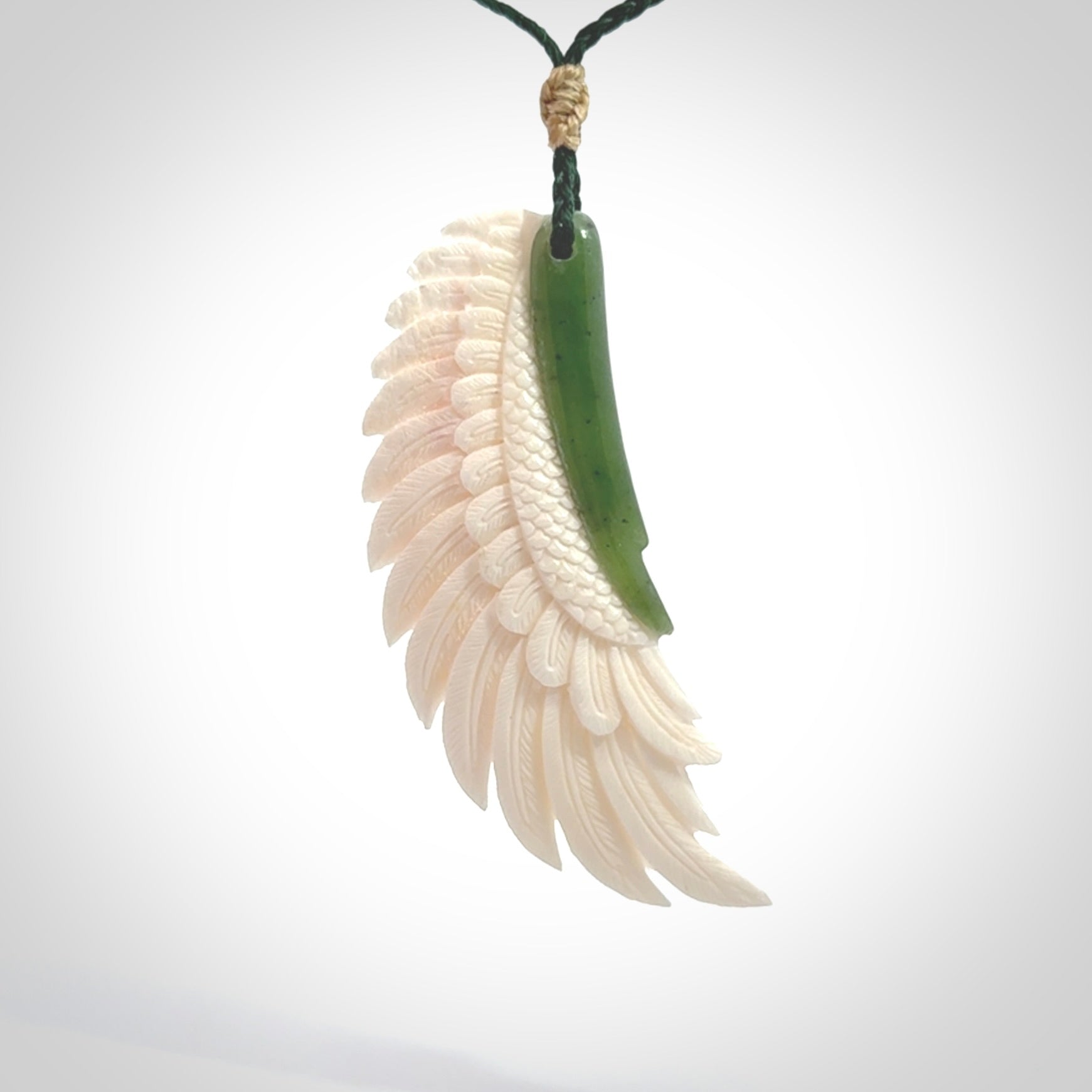 This photo shows a beautiful bone and jade wing pendant.