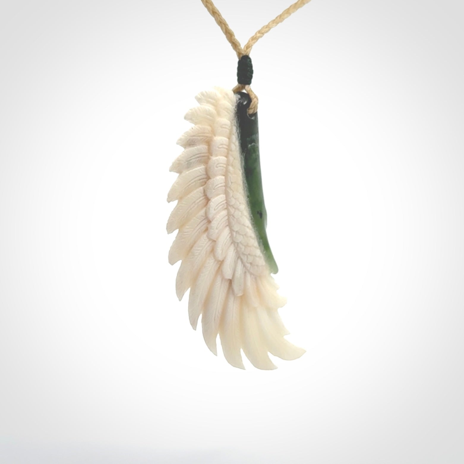 This photo shows a beautiful bone and jade wing pendant.