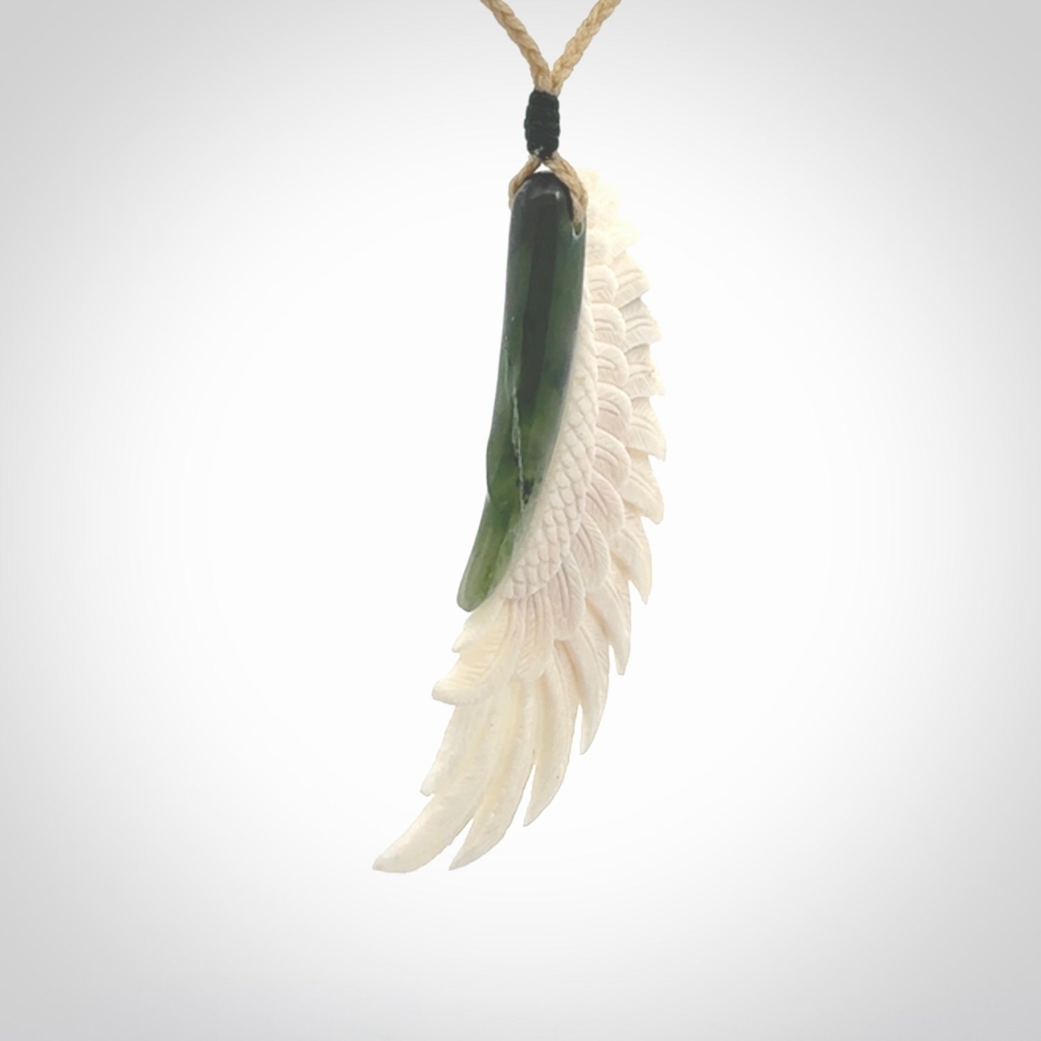 This photo shows a beautiful bone and jade wing pendant.
