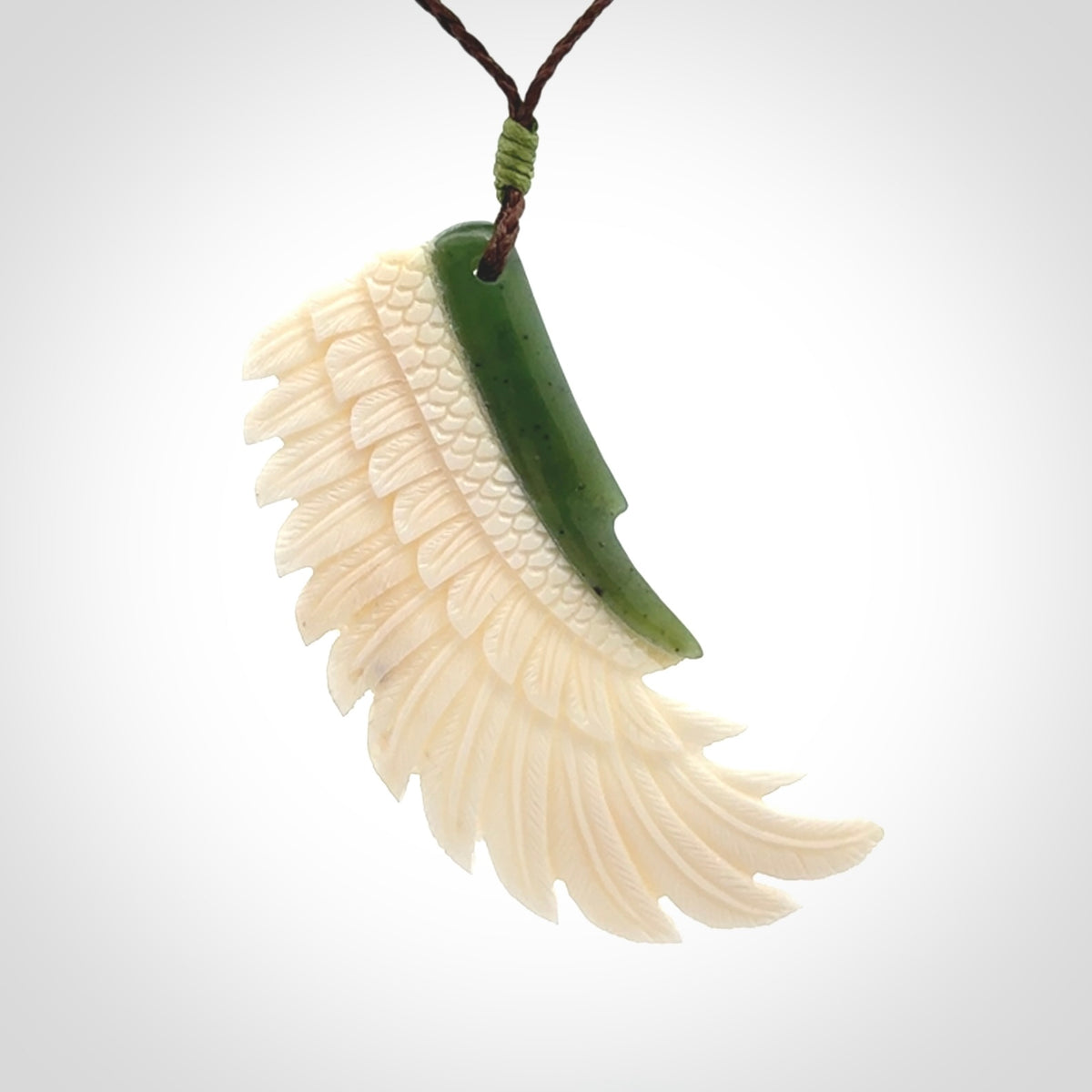 This photo shows a beautiful bone and jade wing pendant.