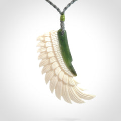 This photo shows a beautiful bone and jade wing pendant.