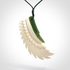 This photo shows a beautiful bone and jade wing pendant.