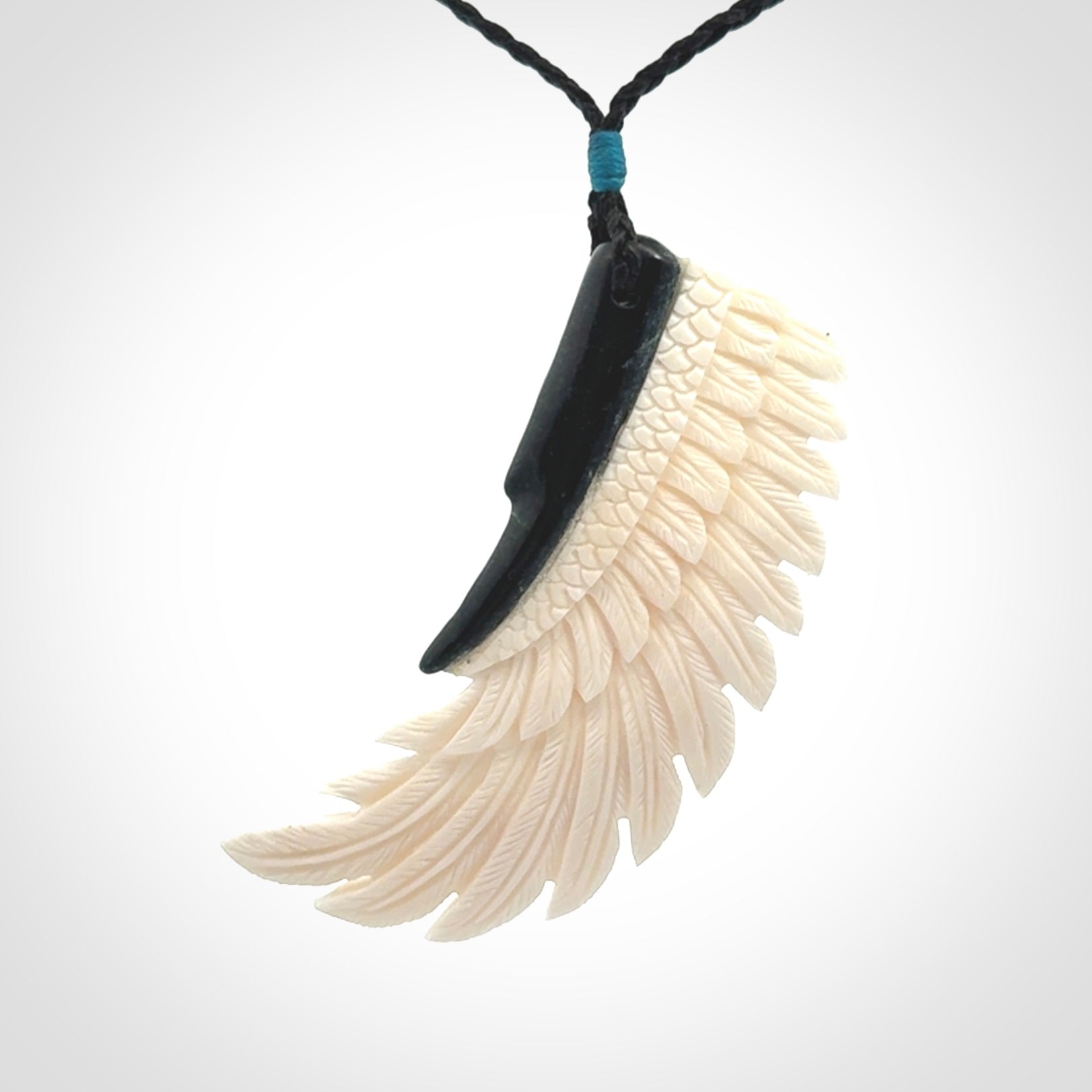 This photo shows a beautiful bone and jade wing pendant.