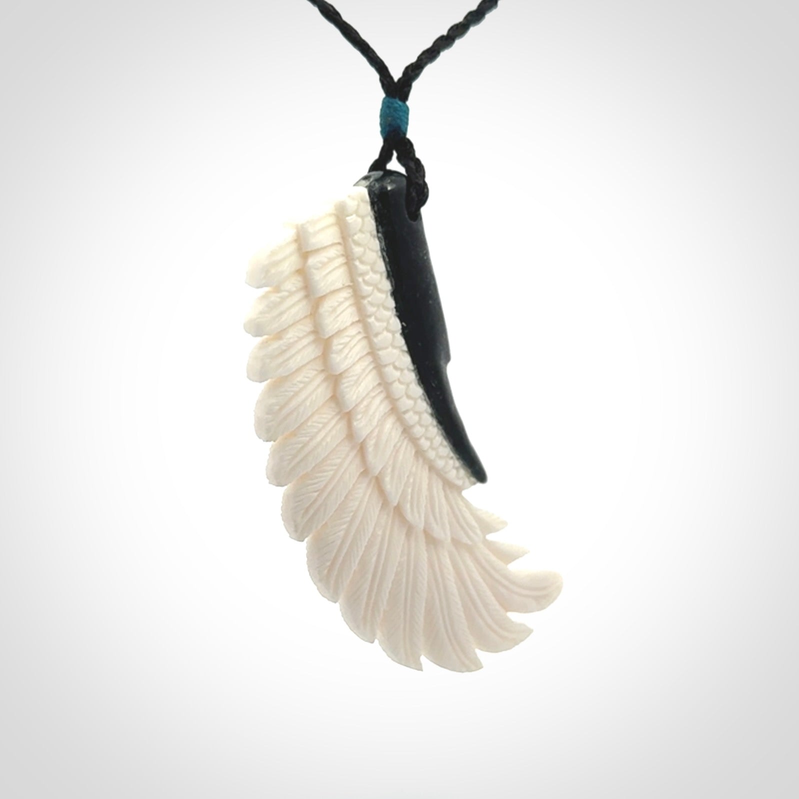 This photo shows a beautiful bone and jade wing pendant.