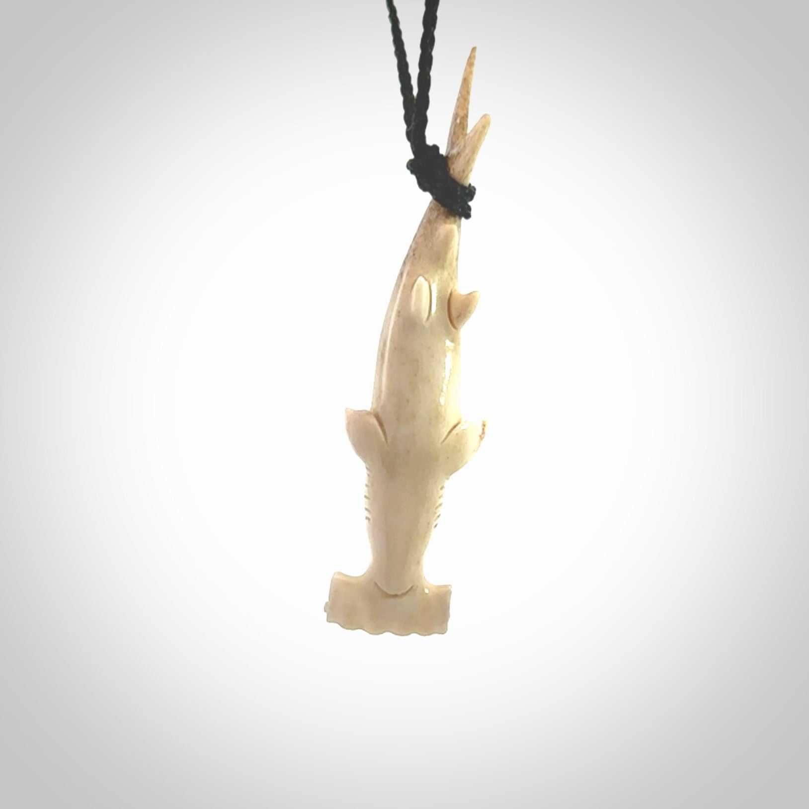Winghead or hammerhead shark pendant. Hand carved from deer antler by NZ Pacific. Hand carved bone jewellery for sale online.