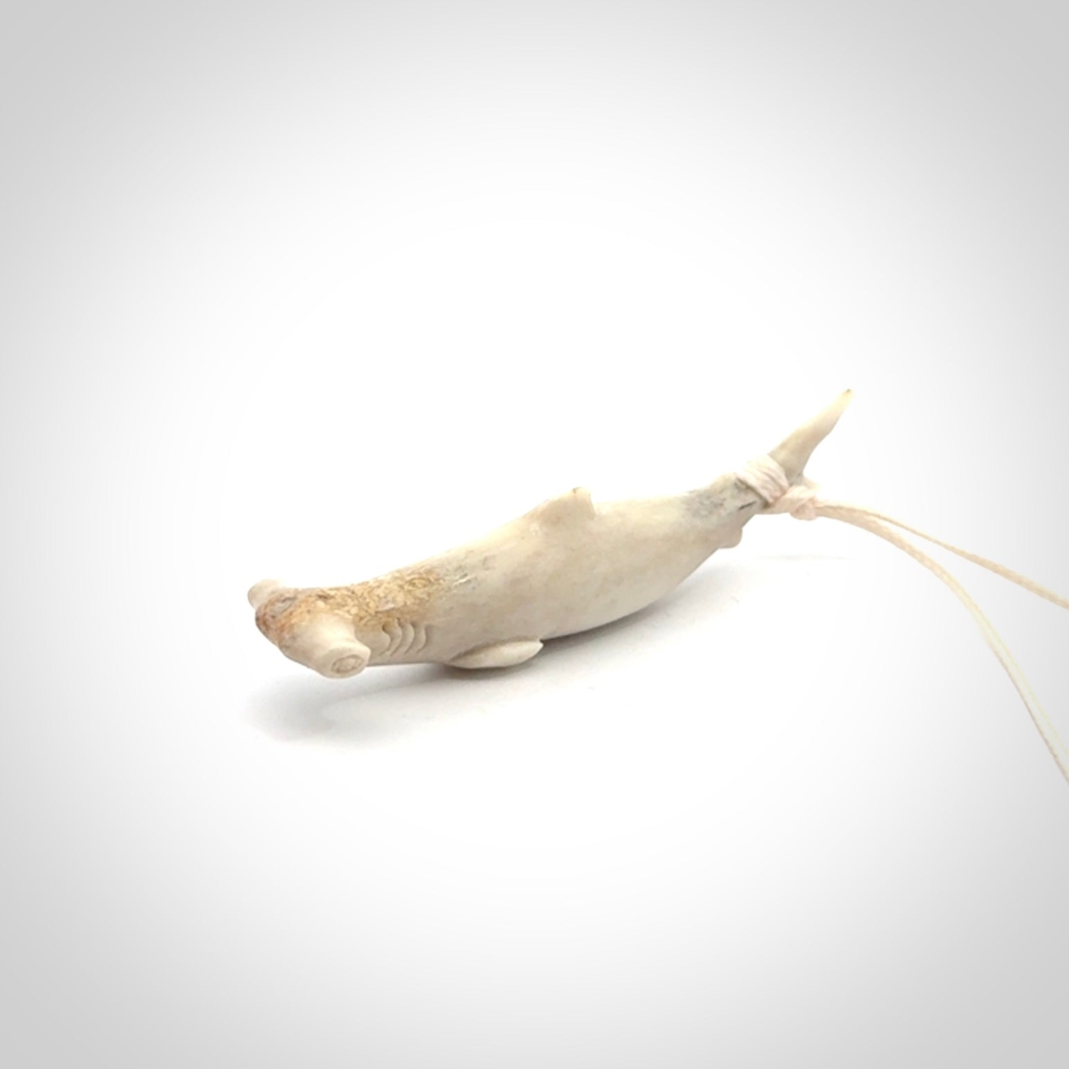 Winghead or hammerhead shark pendant. Hand carved from deer antler by NZ Pacific. Hand carved bone jewellery for sale online.