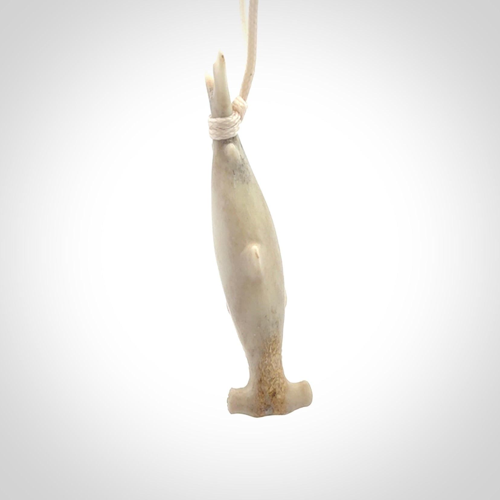Winghead or hammerhead shark pendant. Hand carved from deer antler by NZ Pacific. Hand carved bone jewellery for sale online.