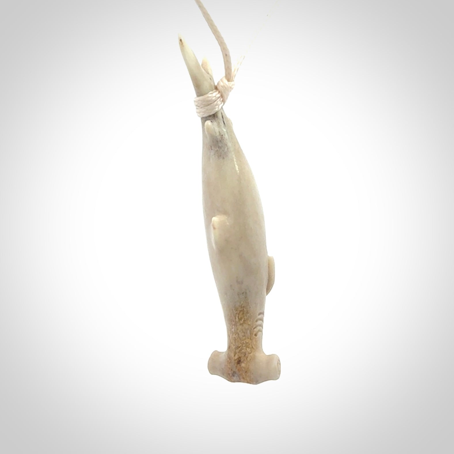 Winghead or hammerhead shark pendant. Hand carved from deer antler by NZ Pacific. Hand carved bone jewellery for sale online.