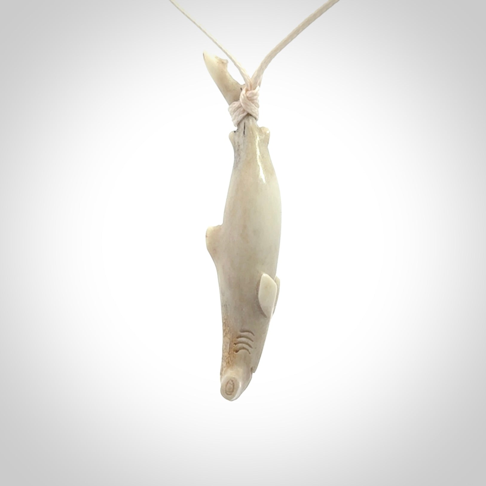 Winghead or hammerhead shark pendant. Hand carved from deer antler by NZ Pacific. Hand carved bone jewellery for sale online.