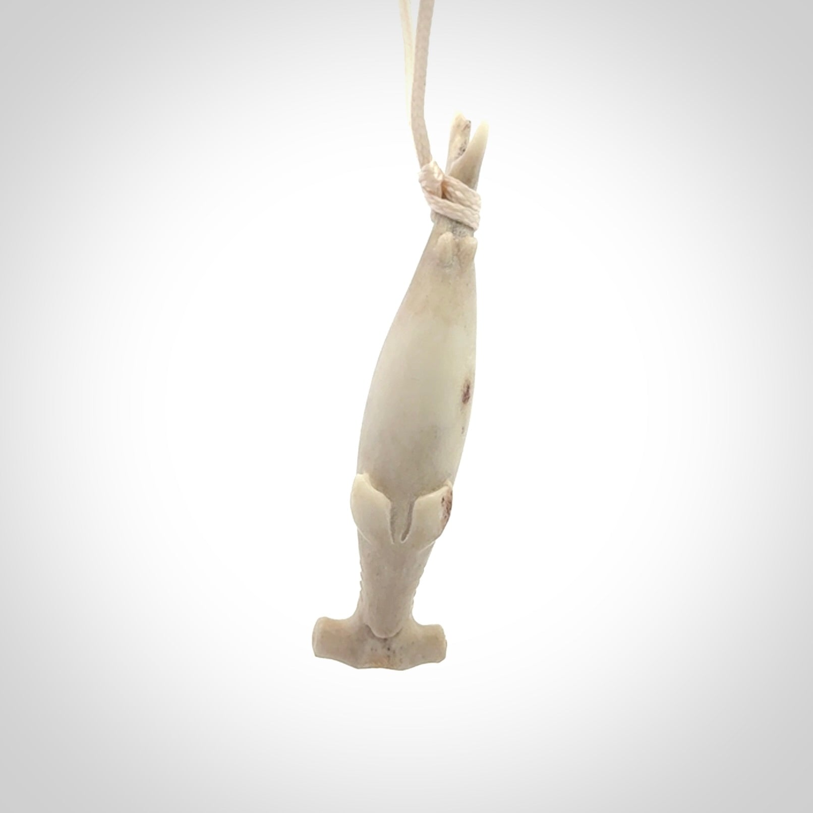 Winghead or hammerhead shark pendant. Hand carved from deer antler by NZ Pacific. Hand carved bone jewellery for sale online.