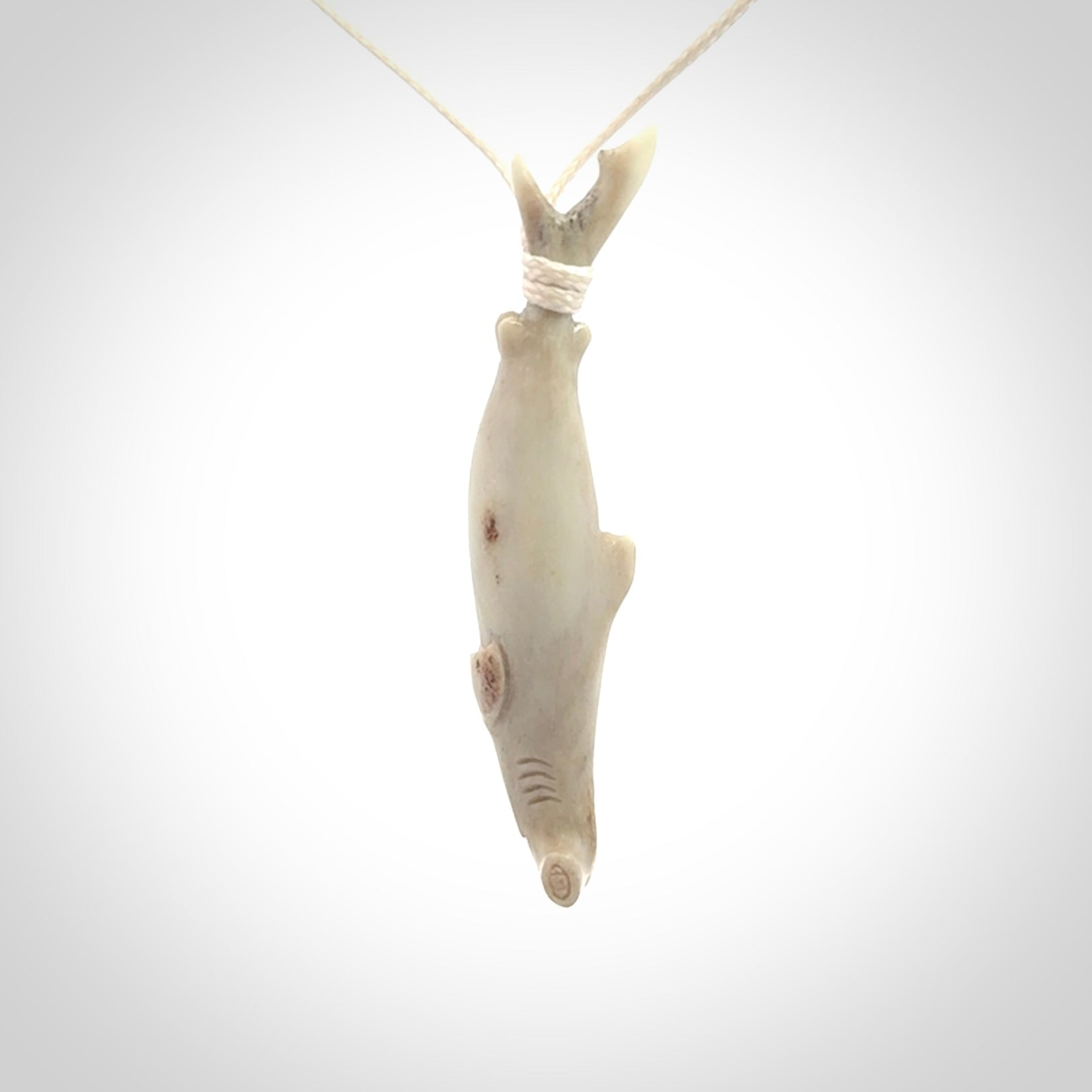 Winghead or hammerhead shark pendant. Hand carved from deer antler by NZ Pacific. Hand carved bone jewellery for sale online.