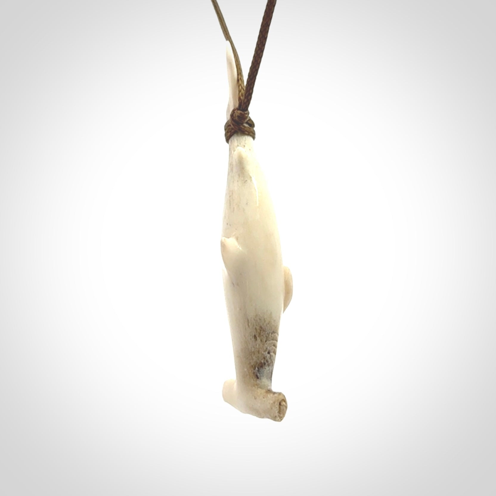 Winghead or hammerhead shark pendant. Hand carved from deer antler by NZ Pacific. Hand carved bone jewellery for sale online.