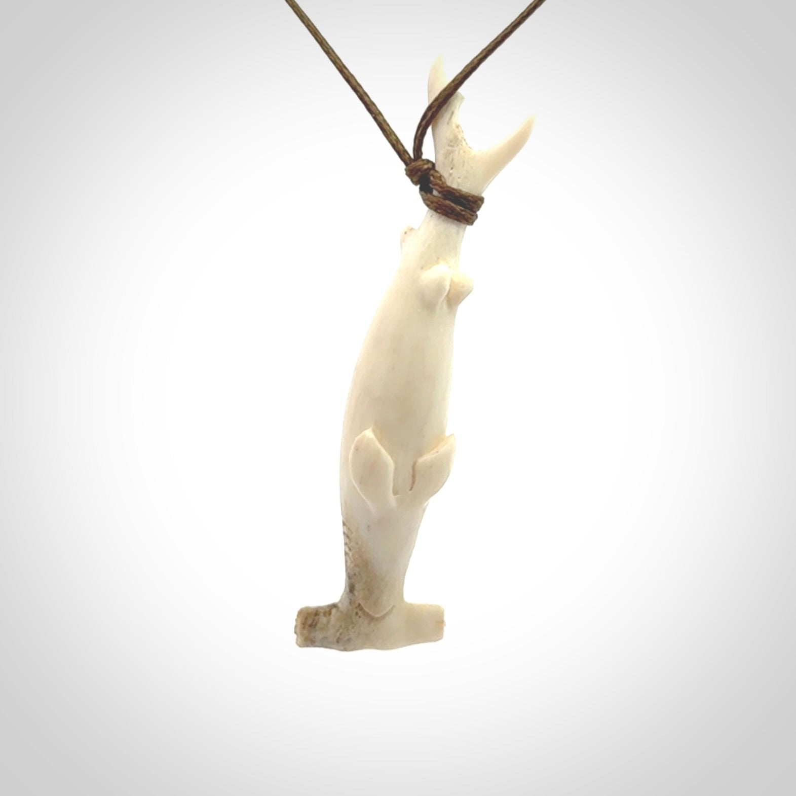 Winghead or hammerhead shark pendant. Hand carved from deer antler by NZ Pacific. Hand carved bone jewellery for sale online.