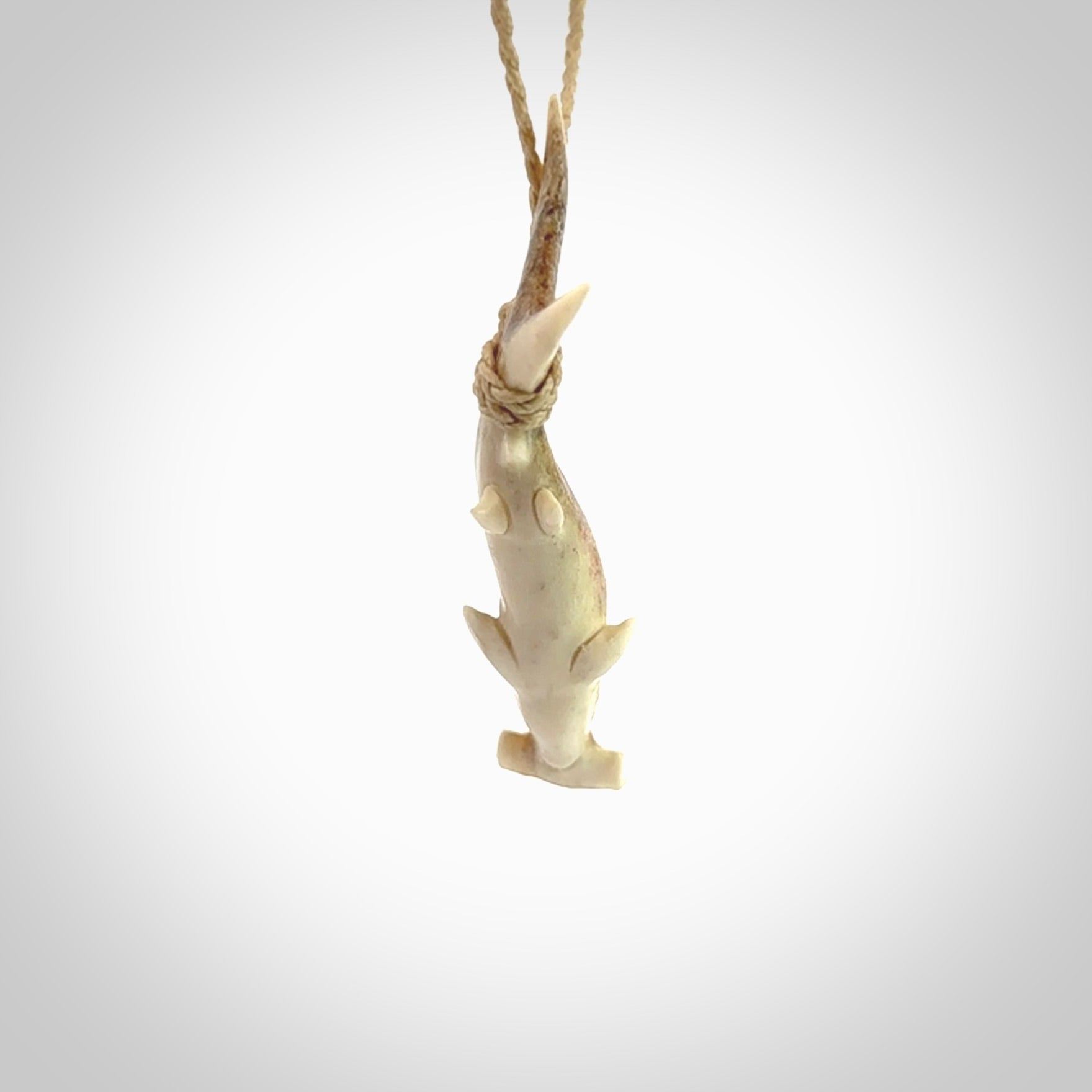 Winghead or hammerhead shark pendant. Hand carved from deer antler by NZ Pacific. Hand carved bone jewellery for sale online.