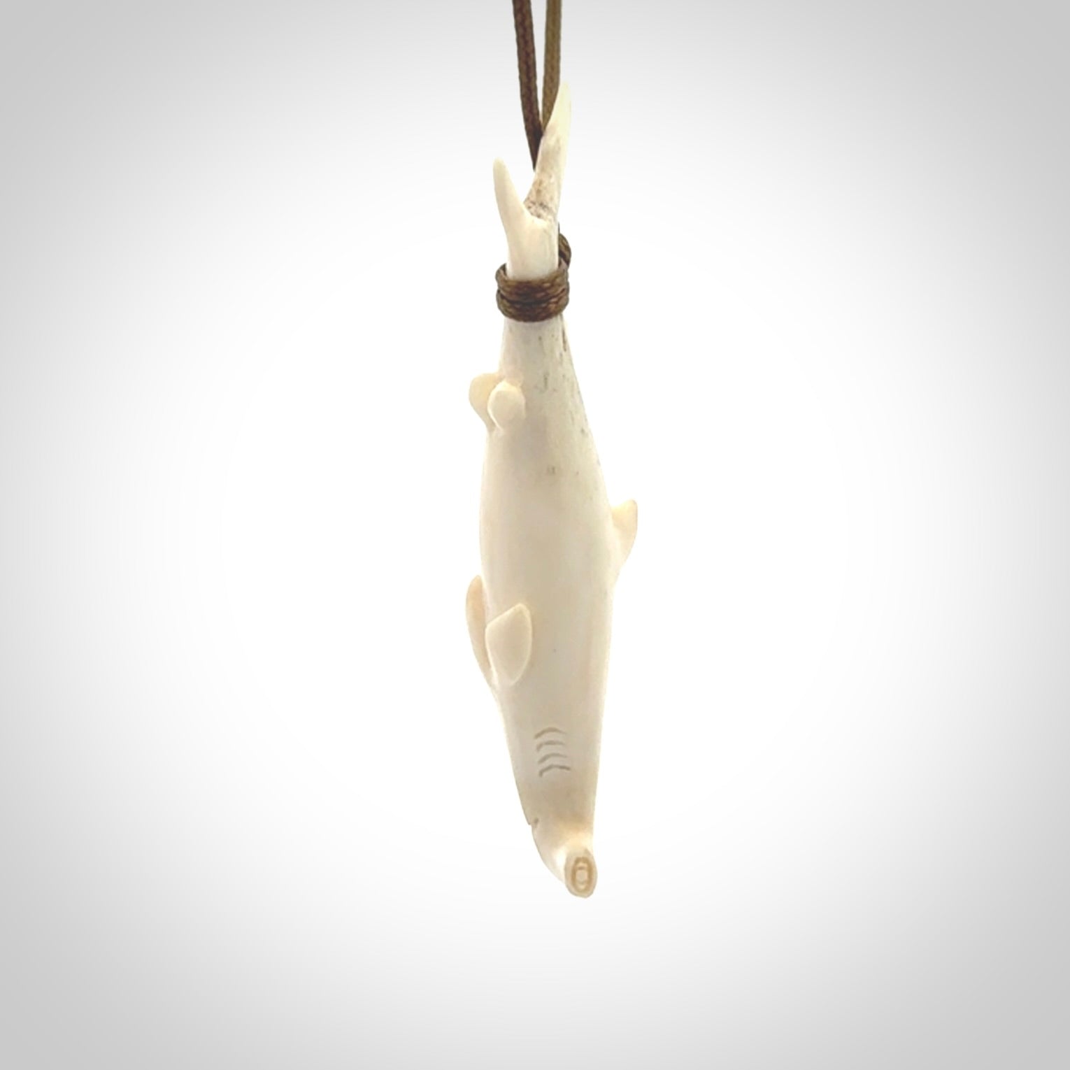 Winghead or hammerhead shark pendant. Hand carved from deer antler by NZ Pacific. Hand carved bone jewellery for sale online.