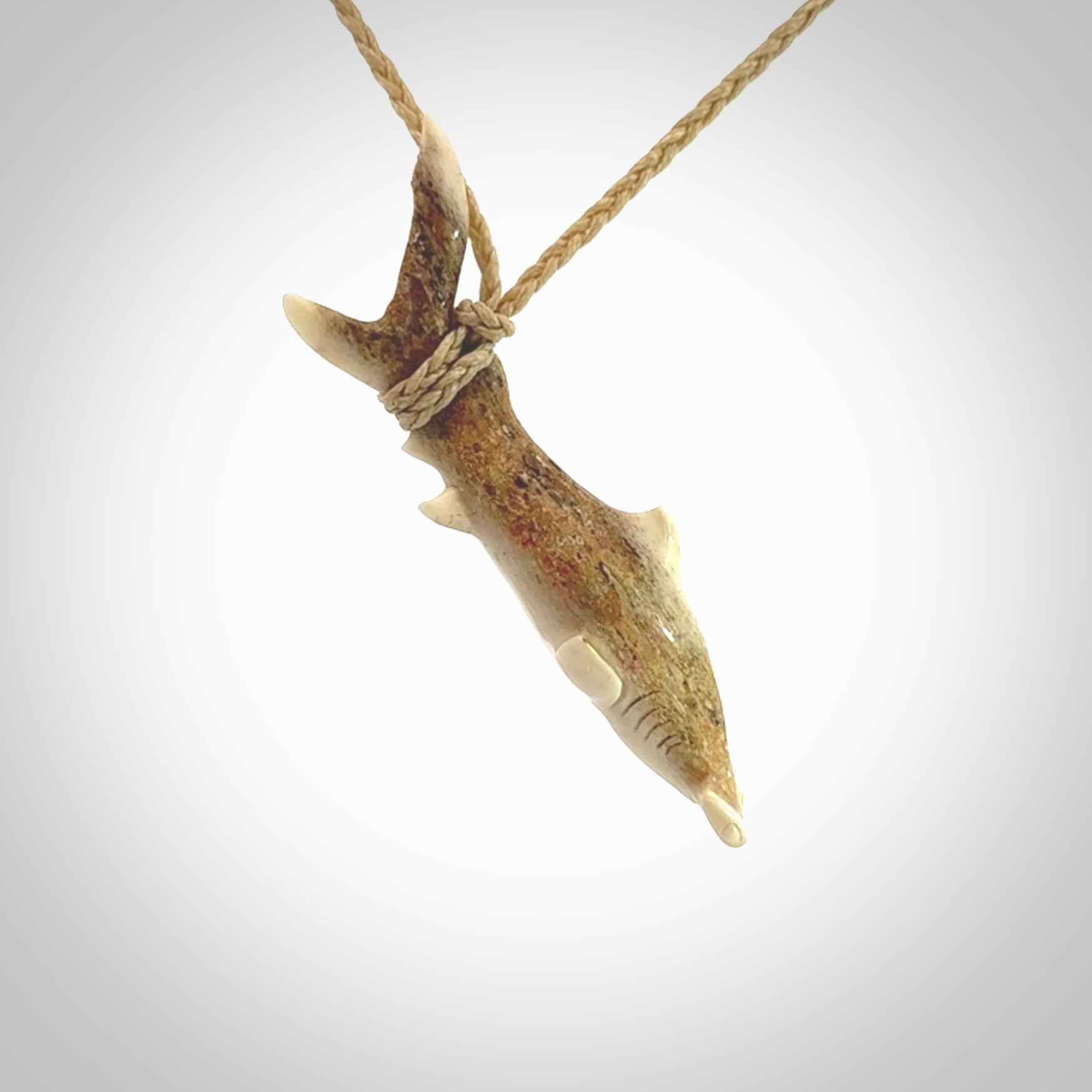 Winghead or hammerhead shark pendant. Hand carved from deer antler by NZ Pacific. Hand carved bone jewellery for sale online.