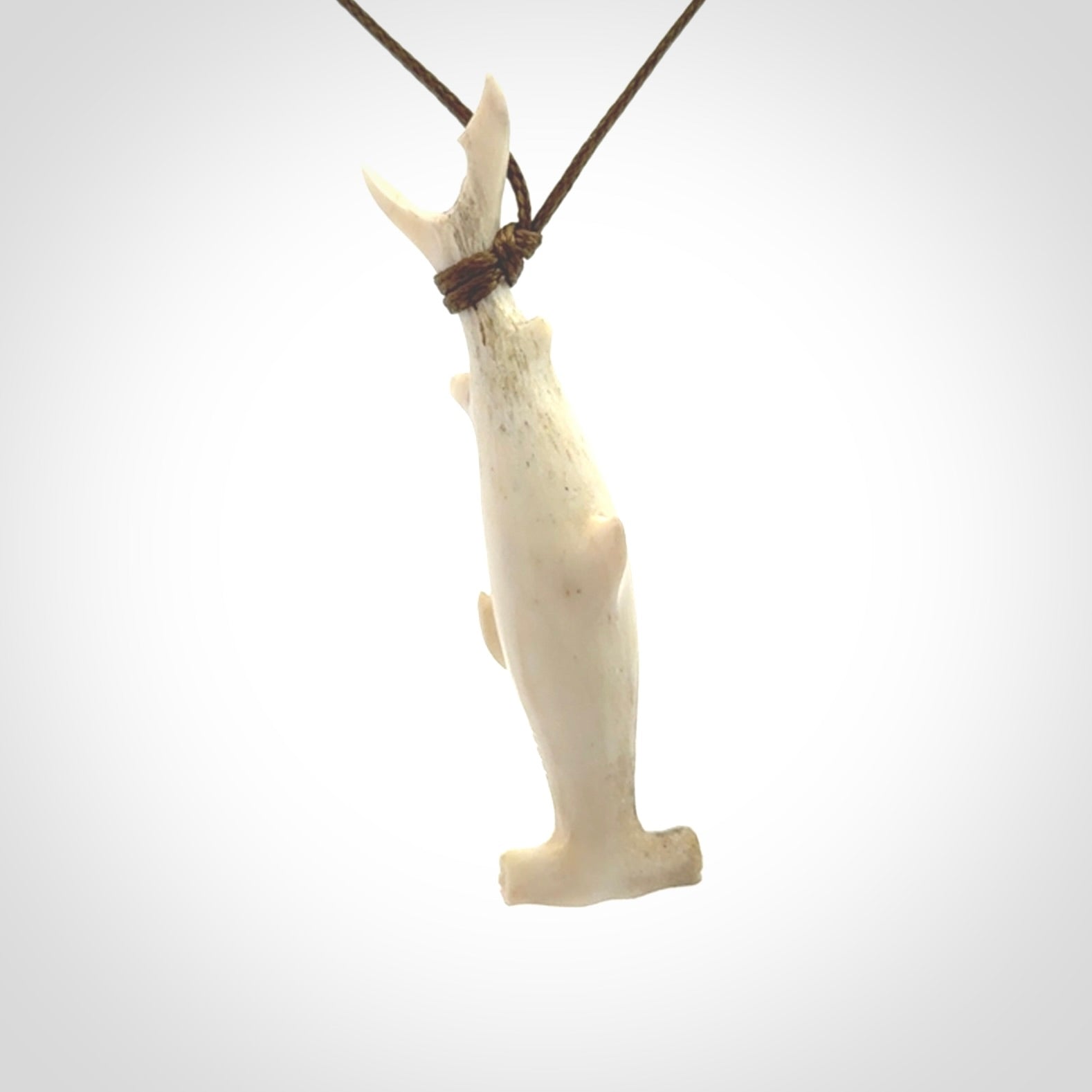 Winghead or hammerhead shark pendant. Hand carved from deer antler by NZ Pacific. Hand carved bone jewellery for sale online.