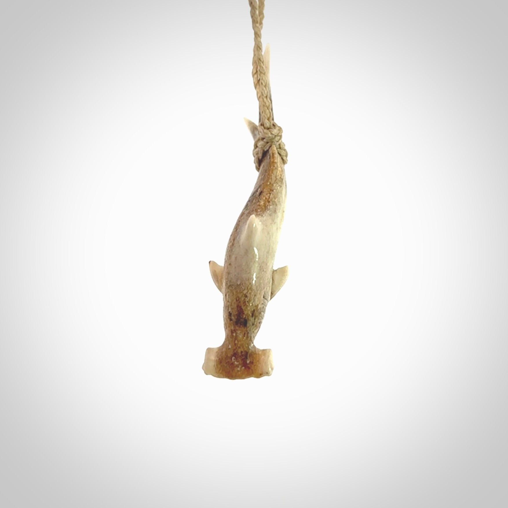 Winghead or hammerhead shark pendant. Hand carved from deer antler by NZ Pacific. Hand carved bone jewellery for sale online.