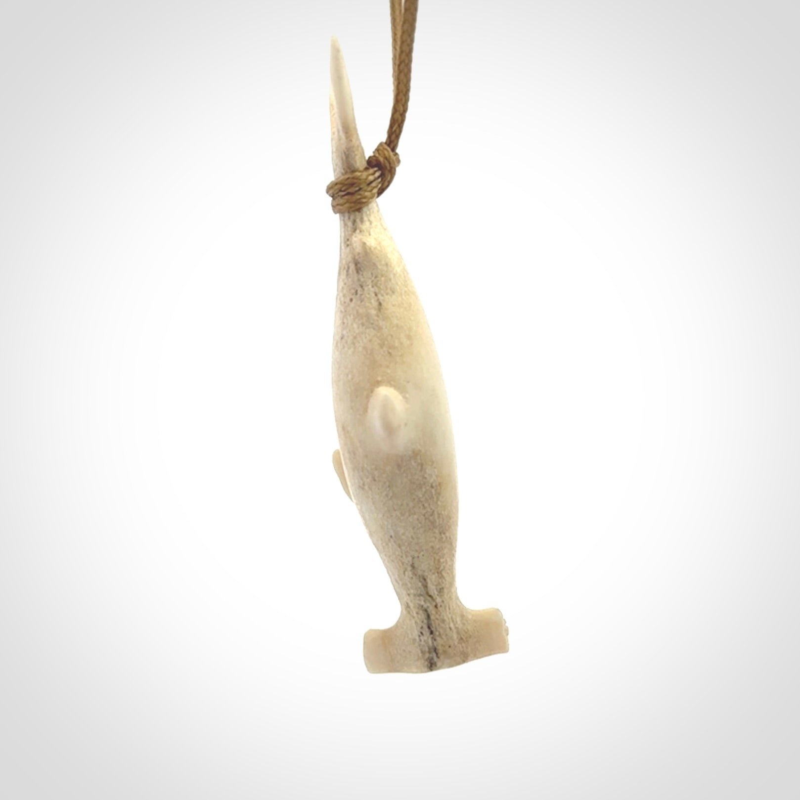 Winghead or hammerhead shark pendant. Hand carved from deer antler by NZ Pacific. Hand carved bone jewellery for sale online.